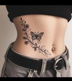 a woman's stomach with a butterfly tattoo on her belly and the bottom part of her abdomen