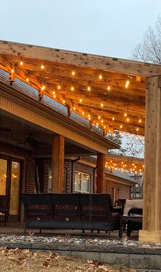 an outdoor covered patio with string lights