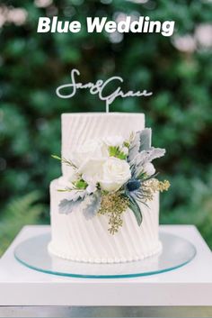 a white wedding cake sitting on top of a table