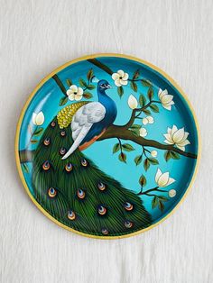 a plate with a peacock painted on it