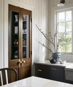 a kitchen with black cabinets and white counter tops