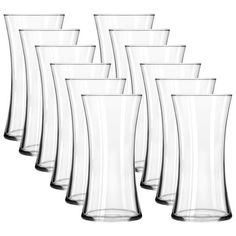 a set of six clear vases sitting next to each other on a white background