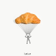 a croissant with a person holding on to it's back as if they were parachuting