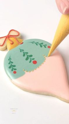 a cookie shaped like an ornament with a pen sticking out of it's tip