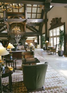 a living room filled with lots of furniture and decor on top of a carpeted floor