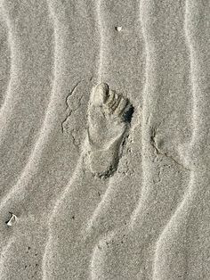 footprints in the sand at the beach