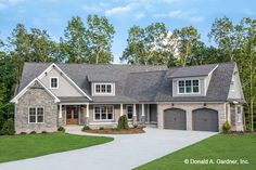 a large house with two garages and lots of windows on the front of it