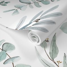 a white wallpaper with green leaves on it