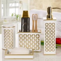 bathroom accessories including toothbrushes, soap dispenser and other items