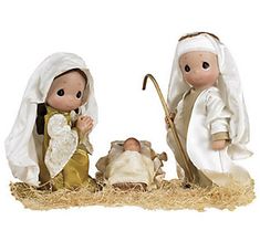 two figurines, one with a baby jesus and the other holding an umbrella