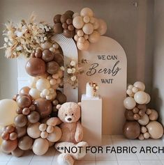 there is a teddy bear and balloons on the floor in front of a sign that says, we can baby wait not for fabric arch