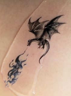 a dragon tattoo on the back of a woman's stomach