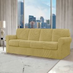 a living room with a yellow couch in front of a window and cityscape