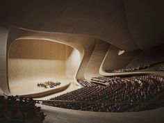 an auditorium filled with lots of people sitting in seats