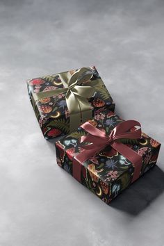 two wrapped presents sitting on top of each other