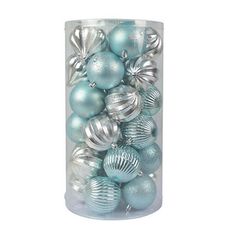 a clear container filled with blue and silver christmas baubles on a white background