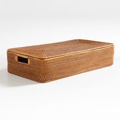 an empty wicker box with handles on a white background