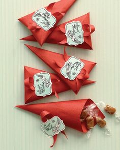 four candy cones wrapped in red and white paper