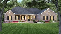 a brick house with black shutters on the front and side windows is surrounded by lush green grass