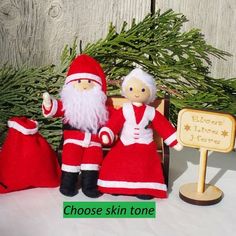 two santa claus dolls sitting on a bench with a sign that says choose skin tone