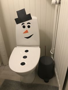 a toilet with a snowman painted on it