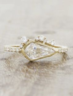 an engagement ring with a pear shaped diamond