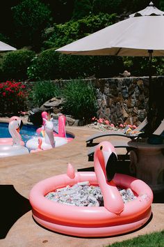 an inflatable pool with flamingos sitting on it