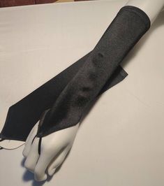 "Beautiful Formal Gloves Black Fingerless Gloves   Stretchy satin  One size fit most (S-XL) Regular women's size DESCRIPTION: These are gorgeous gloves done in all satin. There is a loop that goes around the middle finger.  MEASUREMENTS: ONE SIZE/Misses Regular Color: Black Material: satin / polyester Size: 11\" inches from the knuckle to the forearm opening. The opening stretches to 10\" in circumference.  Masquerade, Valentine's day, dance, stage productions, theatrical, pageants and for many One Finger Gloves, Finger Loop Gloves, Edgy Gloves, Black Silk Gloves, Black Gloves Outfit, Fingerless Gloves Aesthetic, Black Gloves Fingerless, Gothic Gloves, Gloves Aesthetic