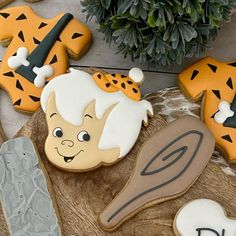 decorated cookies are sitting on a wooden table