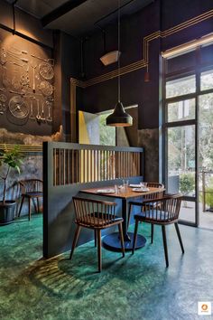 a restaurant with wooden tables and chairs in front of a large glass door that leads to an outside patio