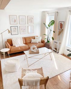 a living room filled with lots of furniture and pictures on the wall above it's windows