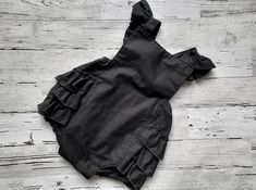 "How about a Black romper perfect for summer!  So crisp and vintage with a modern twist  with luscious black ruffles!  Your little princess will look so cute in this little vintage looking ruffled bottom romper.  It has the black fabric straps which criss cross in the back and has flutter sleeves.  They snap at the back waist and have two options that give her room to grow! Front is fully lined.  100% cotton fabric is machine washable in cold, tumble dry low.  I hope you love this little romper Girl 1st Birthday Cake, Halloween Party Girls, Baby Bubble Romper, Black Toddler, 1st Birthday Cake Smash, Baby Bubble, Toddler Romper, 1st Birthday Cake, Black Baby