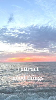 an ocean with the words attract good things in front of it and a sunset over the water