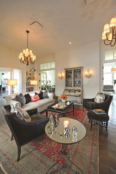 a living room filled with furniture and lots of windows