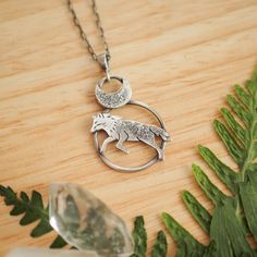 Nature inspired silver wolf pendant with crescent moon. Pendant has the form of a round medallion with the silhouette of a jumping wolf. From the top it is complemented by a silver crescent moon, finished with raw texture that makes every necklace one of a kind and unique. The pendant is hanged on a delicate sterling silver chain. A great gift idea for romantics and forest lovers. Or maybe it could be your spirit animal talisman? Materials: sterling silver; Measurements: - pendant: about 1" x 1. Silver Wolf Pendant Necklace, Silver Wolf Design Round Pendant Necklace, Silver Necklace With Wolf Design Round Pendant, Silver Round Pendant Necklace With Wolf Design, Silver Wolf Design Pendant Necklace, Jumping Wolf, Moon Spirit, Raw Texture, Magic Jewelry