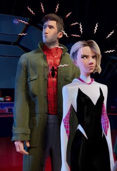 two people standing next to each other in front of a spider man and woman costume