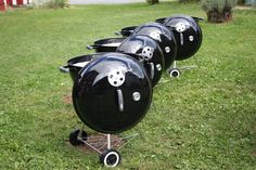 black bbq grills lined up in the grass