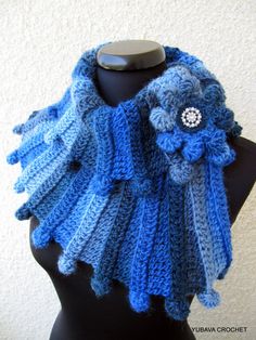 a blue knitted scarf on top of a mannequin