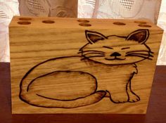 a wooden box with a drawing of a cat sitting on it's front paws