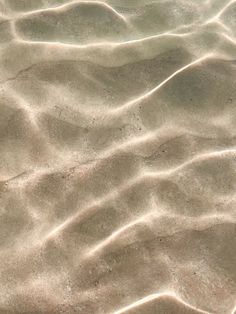 sand and water with small waves in it