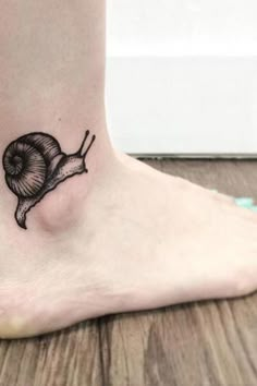 a small snail tattoo on the ankle