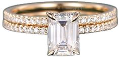 an emerald cut diamond ring with two rows of diamonds around it