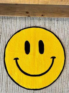 a yellow smiley face rug on the floor