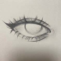 a pencil drawing of an eye with long lashes on the bottom half of its iris