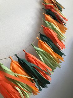 some orange, green and yellow streamers hanging from a wall