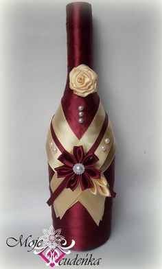 a wine bottle decorated with flowers and pearls