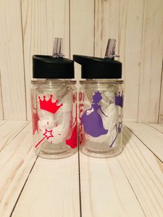 two glass jars with different designs on them