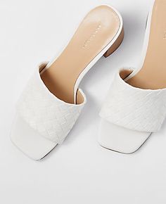 Step effortlessly from your morning coffee to evening cocktails with the Ann Taylor Woven Leather Block Heel Sandals. These chic sandals are a perfect blend of comfort and style, featuring an open toe design and a comfortably padded footbed.

- Size: 9 1/2
- Color: Winter White
- Material: 100% Faux Leather
- Heel Height: 2 3/4 inches
- Gender: Female
- Age Group: Adult

Crafted with intricate woven faux leather, these sandals elevate any outfit with their sleek block heel and pristine winter wh Spring Woven Leather Mules With Block Heel, Formal Sandals With Woven Sole And Block Heel, Summer Open Toe Mules With Intrecciato Weave, Spring Woven Leather Sandals With Low Heel, Summer Woven Leather Heels With Low Heel, Low Heel Woven Leather Heels For Summer, Spring Open Toe Heels With Intrecciato Weave, Summer Formal Woven Leather Mules, Formal Woven Leather Mules For Summer