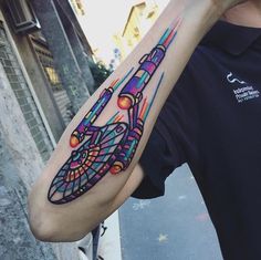 a man with a colorful tattoo on his arm