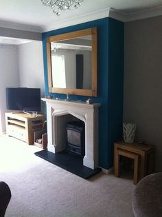 a living room with a fireplace and mirror